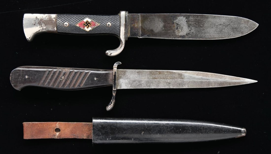 WWII GERMAN EDGED WEAPONS.: 1) HJ. A classic example of an HJ side knife measuring 9 1/8” overall. Plain blade stamped on the reverse “(two bottles) CARL HEIDELBERG SOLINGEN” & “RZM M7/65 1938”. 2-Piece bla