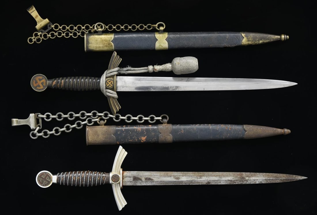 2 WWII GERMAN 1st MODEL LUFTWAFFE DAGGERS.: 1) Overall length: 19 1/8”. Blade is marked near the hilt “(logo) GEBR. HELLER MARIENTHAL b. SCHWEINA/THR.”. Plated crossguard & pommel w/ mobile party symbols. Wire-wrapped blue leather