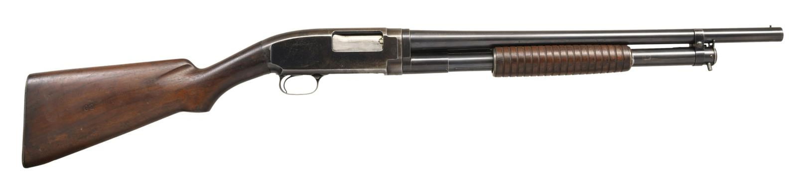 WINCHESTER MODEL 12 RIOT PUMP ACTION SHOTGUN.: Cal. 12 GA. S# 166895. Bbl. 20 1/2". Model 12 pump action riot shotgun mfg. by Winchester in 1918. The left side of the bbl. is marked "NICKEL STEEL", followed by the Winchester trademark logo, the mo