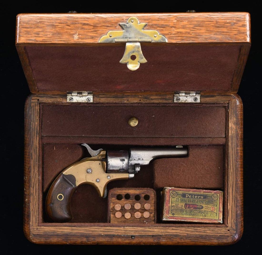 COLT OPEN TOP POCKET REVOLVER WITH CASE.: Cal. 22 RF. S# 90034. Bbl. 2 3/8". Open Top Pocket revolver mfg. by Colt in 1876. The top of the bbl. is marked with Colt's mfg. information, with "22 CAL" marked on the left side of the frame. Brass