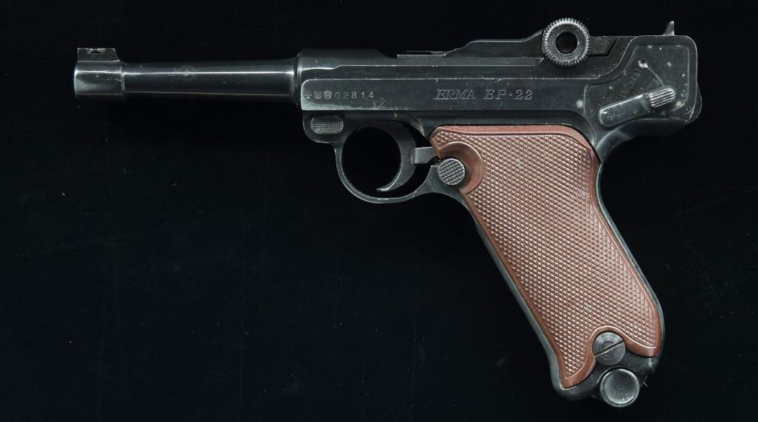 ERMA MODEL EP 22 SEMI AUTO PISTOL.: Cal. 22 LR. S# 02814. Bbl. 4 1/2". Front sight appears broken off. Fixed U-notch rear sight. German made rimfire Luger style pistol. Left side of slide has German proofs w/ 1964 date. Black enamel fin