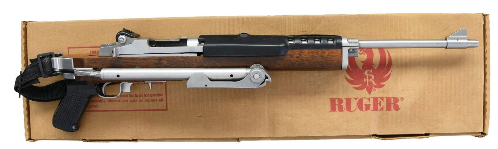 RUGER STAINLESS MINI-14 FOLDER SEMI-AUTO CARBINE.: Cal. 223 Rem. S# 184-67002. Bbl. 18 1/2" with banded serrated blade sight; integral factory receiver sight at rear. Mfg. 1985, as Model 01807, had factory-folded stock correctly utilizing a gas block