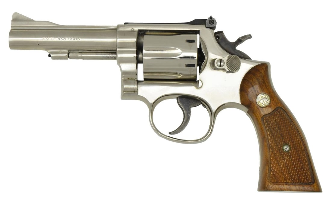 SMITH & WESSON 15-2 DA REVOLVER.: Cal. 38 Spl. S# 13K8957. Bbl. 4", pinned. Ramped serrated blade front sight. Adjustable square-notch rear sight. Mfg. 1977. Nickel finish with a case-colored hammer & trigger. Diamond Magna grips with