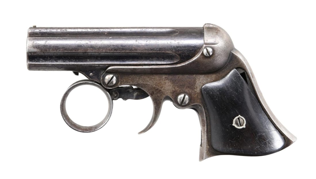 REMINGTON ELLIOT .22 PEPPERBOX DERINGER.: Cal. 22 Short. S# 865. Bbl. 3" five-shot fluted cluster. Bead sight. Action features a ring-type trigger & revolving firing pin. Bbl. group tilts forward for loading. Blue finish. Two-piece rosewood g