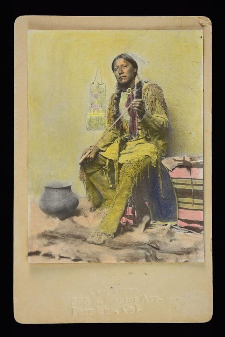 CARL MOON HANDCOLORED PHOTOGRAPH "TAOS ARROW: MAKER". Famous Carl Moon 3.75" x 5" photo mounted on "CARL MOON / 565 N. MENTER AVE / PASADENA, CA" embossed cabinet card, circa 1905. CONDITION: very good, image lifting from board. PROVENANCE: from