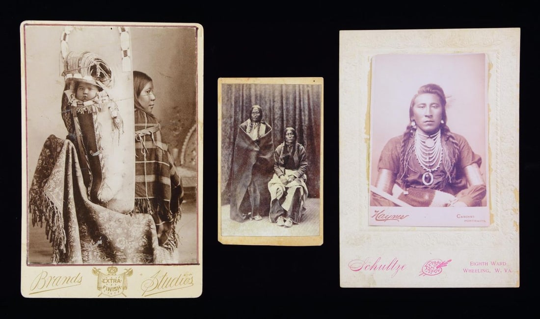 THREE NATIVE AMERICAN PHOTOGRAPHS.: 1) CDV of 2 Indians, ID'd on verso as Cheyenne, "Lame-White-Man" & "Wild Hog". 2) Lithograph mounted on Brands Studio card of young Native American mother posed with large cradle board & papoose. 3) C