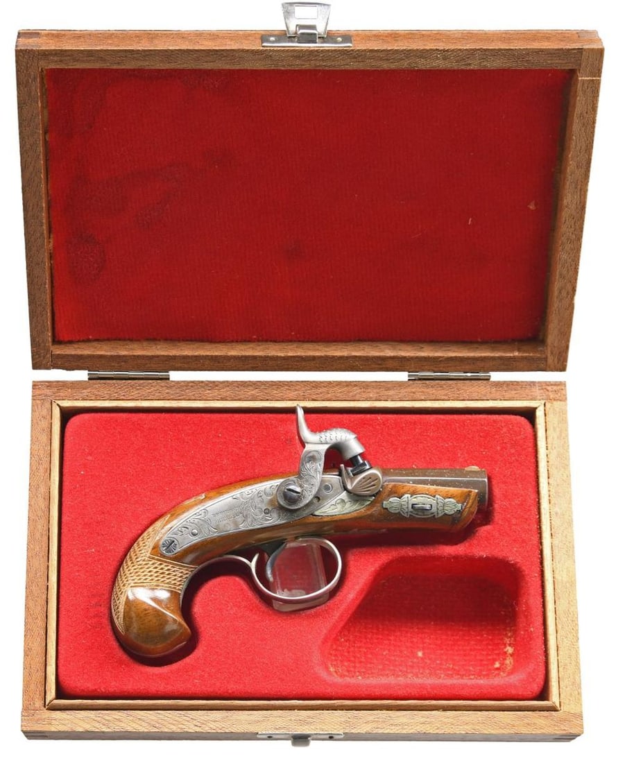 ITALIAN PALMETTO PHILADELPHIA DERRINGER.: Cal. 41. S# 216 (AI = 1982). The 2" barrel has a blade front sight. Back action lock. Wedge-fastened hardwood checkered stock has German silver ornamentation. UNATTACHED ACCESSORIES: matching-numbered