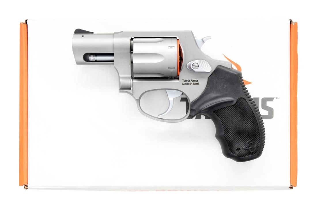 TAURUS 856 DA REVOLVER.: Cal. 38 Spl. S# ACK431886. Bbl. 2". Ramped serrated blade front sight. Fixed rear sight. Stainless finish. Black hard rubber grips w/ Taurus logo. UNATTACHED ACCESSORIES: matching numbered factory box