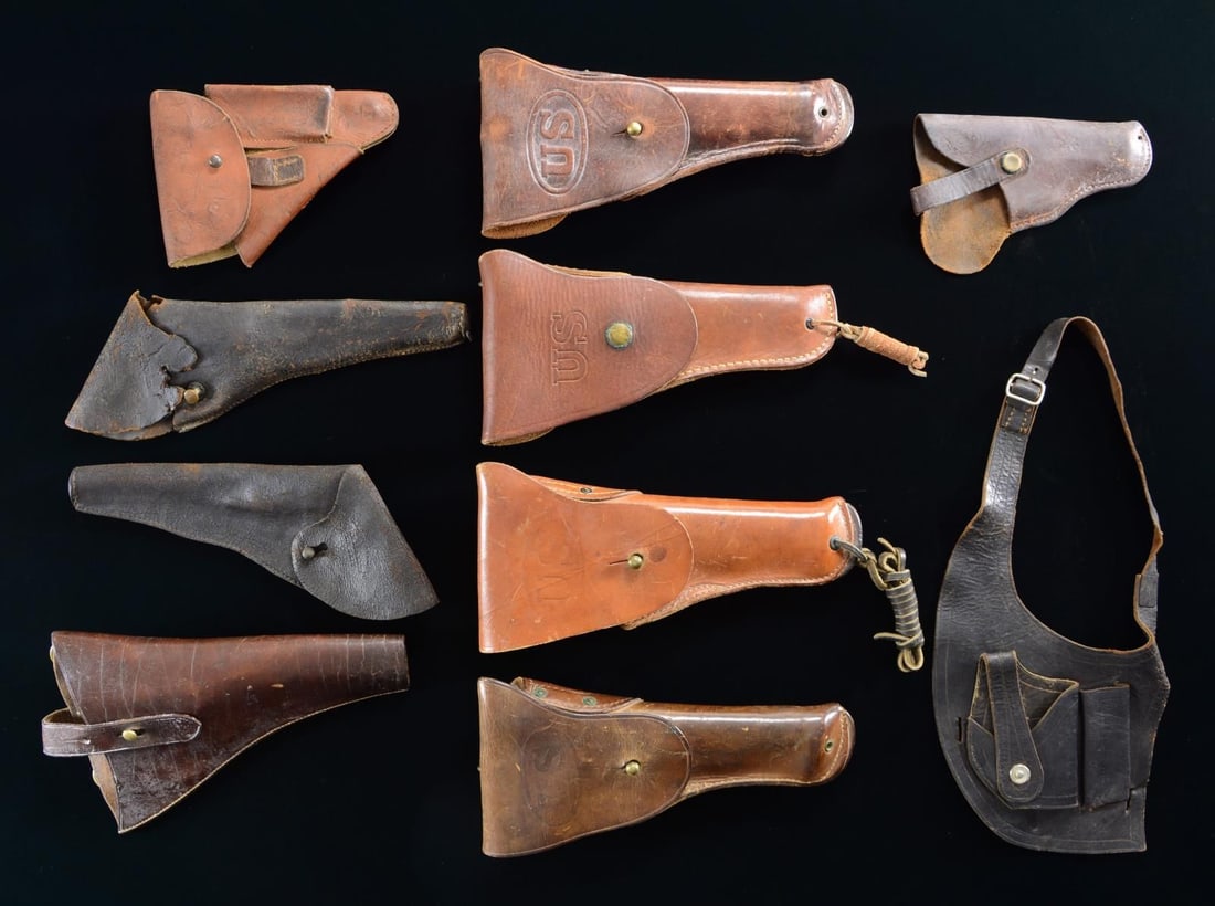 10 MILITARY HOLSTERS.: This fine group of holsters includes 2 WWI 45 cal. automatic holsters. / 1 WWII 45 cal. automatic holster. / 1 Non-military 45 cal. automatic holster. / 1 German PPK-type brown leather holster. / 1 US