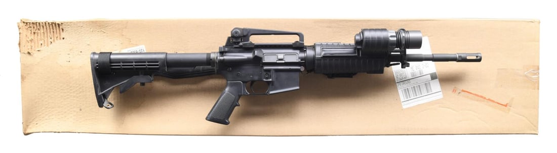 FLAT TOP BUSHMASTER XM15-E2S RIFLE.: Cal. 223 / 5.56. S# BFI437479. Bbl. 16". 1:9 M4 profile barrel, threaded & terminated w/ flash hider. Protected post front sight / gas block / bayonet lug. Round carbine Surefire handguards & lights,