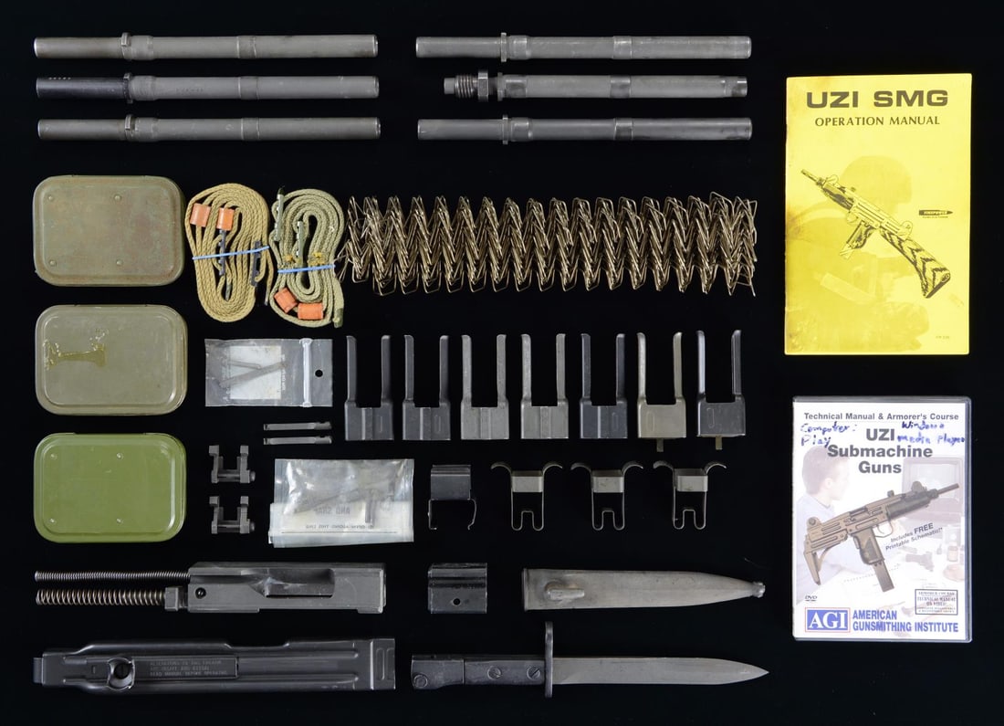 GROUPING OF UZI SPARE PARTS & ACCESSORIES.: This grouping includes 6 Uzi barrels (5 SMG 10.2" and 1 9.25" threaded semi barrel); 1 complete bolt & recoil spring system for a semiautomatic, closed bolt system; 1 non-ratcheting top cover assembly