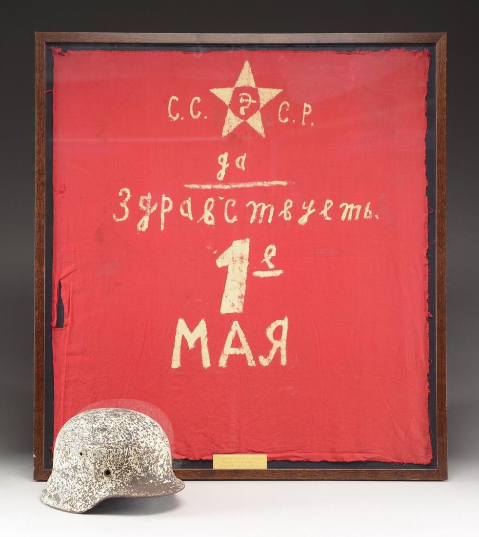 WWII RUSSIAN FLAG CAPTURED AT STALINGRAD &: BATTLEFIELD PICKUP HELMET. 1) FLAG. A homemade Russian flag measuring approx. 30” x 27 1/2" in a wooden frame measuring 32 1/2" x 30”. The frame has an engraved plate at the bottom that re