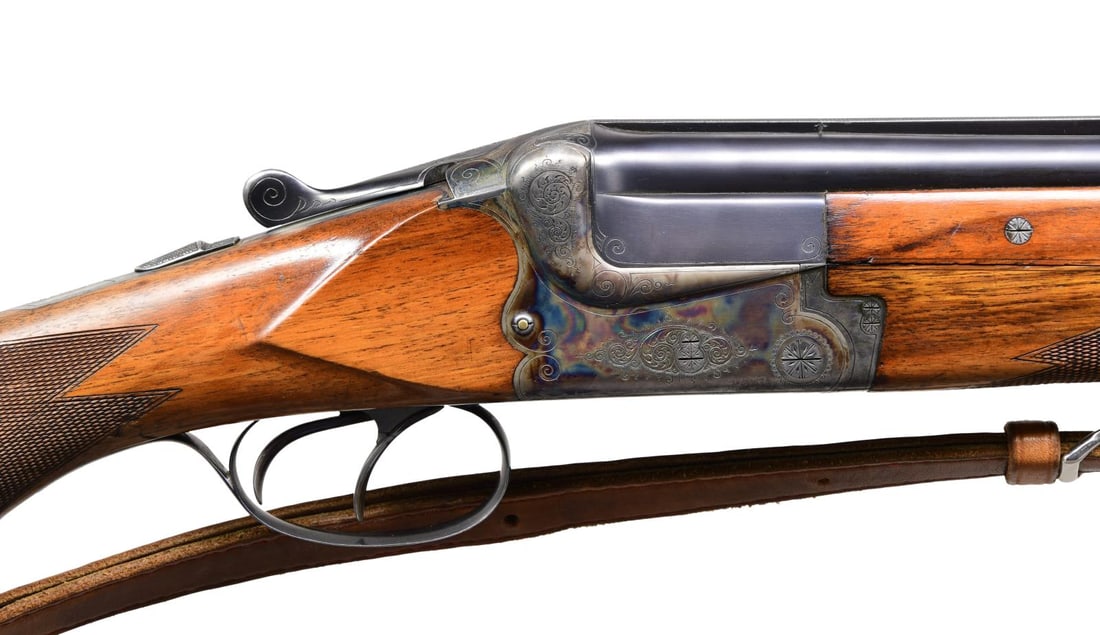 EAST GERMAN MERKEL MODEL 200E O/U SHOTGUN.: Cal. 12 Ga., 2 3/4". S# 44588 (Nov. 1956). The Bohler Stahl 28" barrels have matted top rib with brass front bead. Fixed full chokes. Water tables have East German November 1956 Nitro proofs. Case har