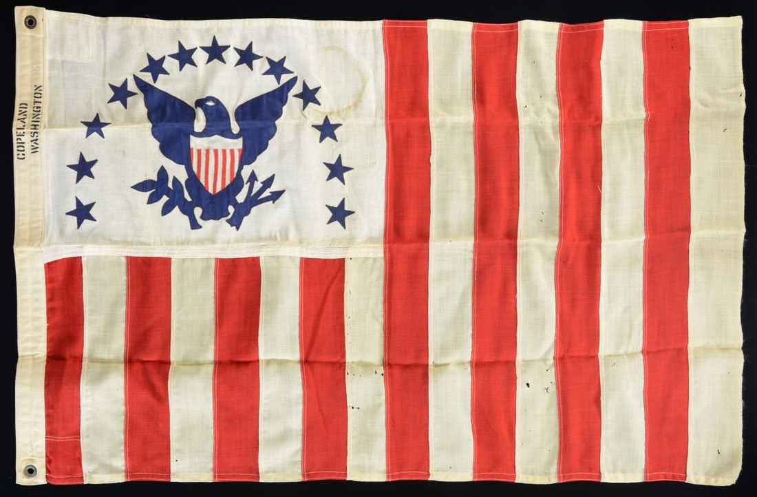 REVENUE CUTTER SERVICE ENSIGN.: This fine revenue cutter ensign measures approx. 47” x 30”. The flag features 16 vertical red and white stripes, a canton showing a blue American eagle with an arc of 13 stars above, and a