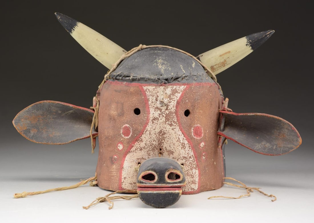NATIVE AMERICAN HOPI STYLE LEATHER & WOOD FULL: HEAD MASK. 9" tall, 8" diameter painted 3-piece leather seamed with rawhide & cord, attached leather ears, wood snout & horns. CONDITION: fair to good, snout is loose and has been resewn and reattache