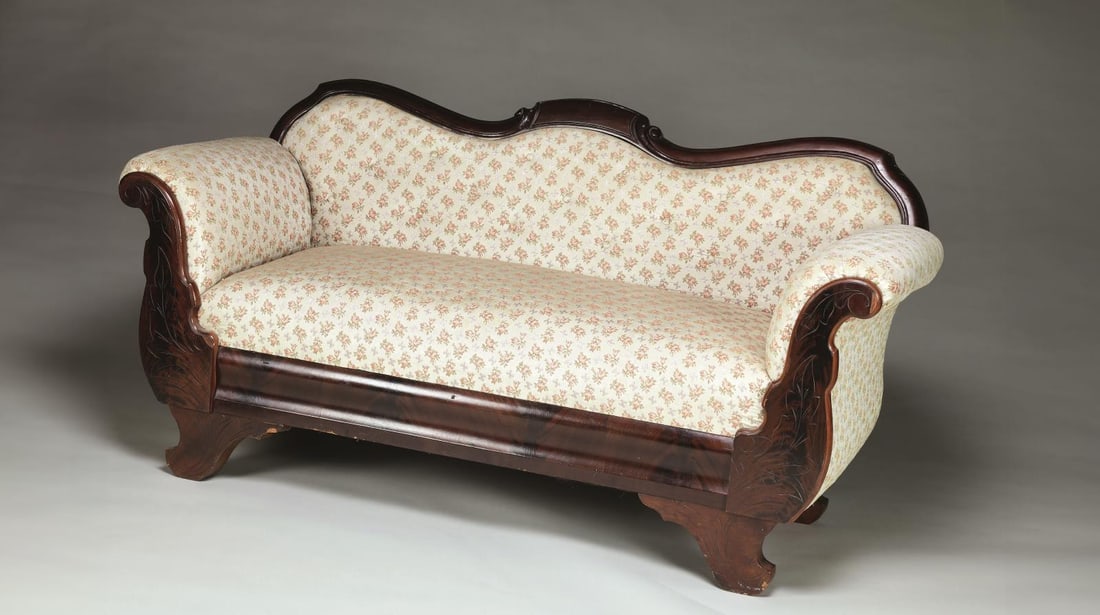 HISTORIC SOFA THAT ONCE BORE THE DYING STONEWALL: JACKSON AT GUINEA STATION, NOW THE JACKSON SHRINE, DIRECT FAMILY DESCENT. This wonderful petite 60" Empire upholstered mahogany sofa was in the room where Stonewall Jackson died and he was laid on it