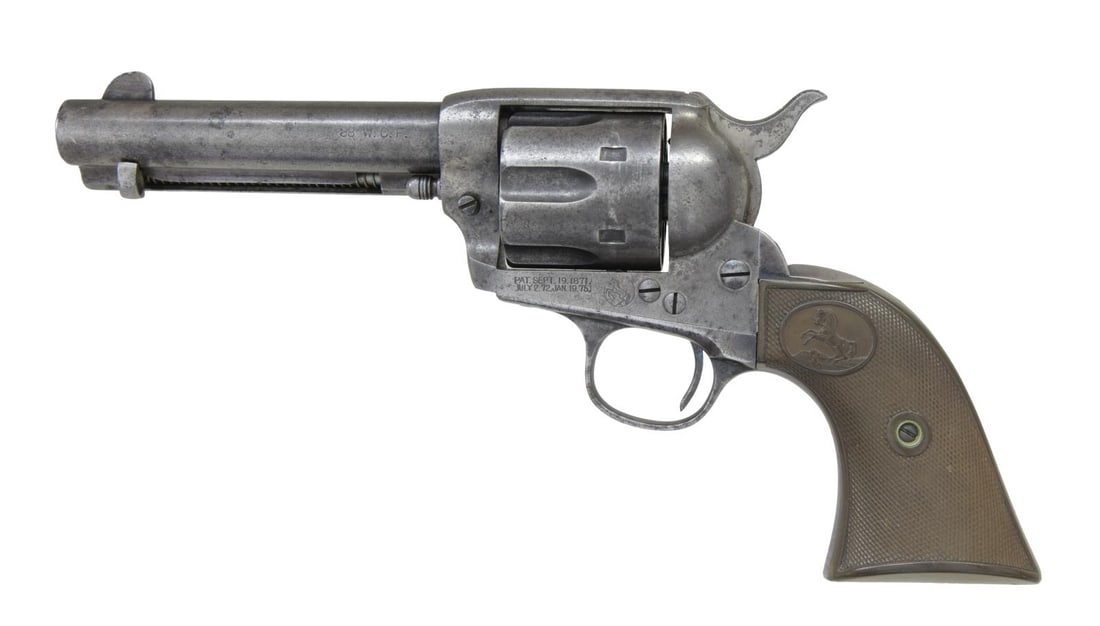 COLT FIRST GENERATION SAA REVOLVER.: Cal. 38 WCF. S# 265376. Bbl. 4 3/4". Six shot fluted cyl. 2 piece checkered hard rubber rampant colt grips. Mfg. 1906. CONDITION: metal has faded gray appearance showing scattered corrosion & very lig