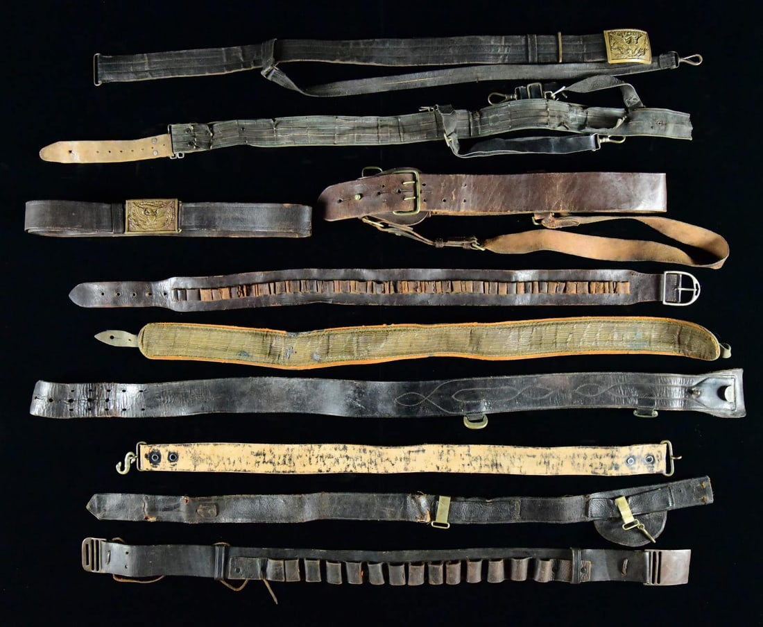 LARGE LOT OF US MILITARY LEATHER, CIVILIAN LEATHER: AND RELATED MATERIAL. This varied lot includes 1 gold bullion-faced shoulder sling. / 1 Cartridge belt for shotguns, with a brass buckle. / 1 Belt clip and boss for a 45-70 bayonet. / 1 Brown leather 