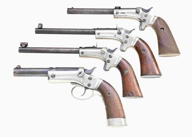 LOT OF FOUR STEVENS TIP UP PISTOLS.