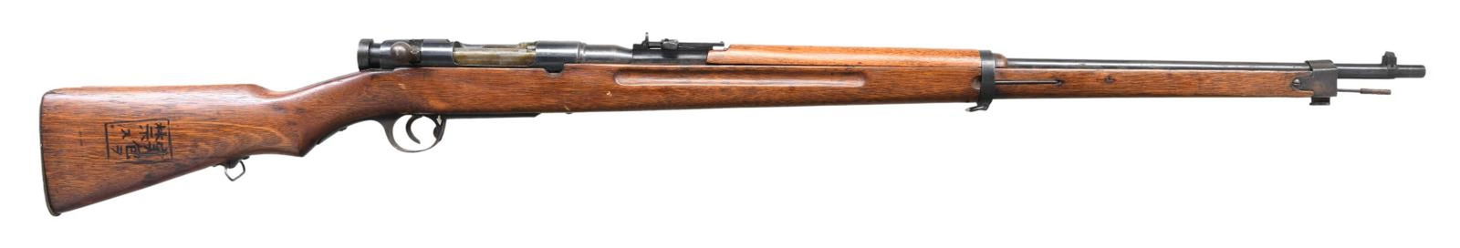 WWII JAPANENSE NAVY TRAINING RIFLE.: Cal. 6.5 Jap Blank. S# 13186. Bbl. 31" smoothbore. Blade front sight. Aperture ladder rear sight graduated to 1700m. Japanese Type 38-style naval training rifle. Chambered for 6.5 blanks, no thought s