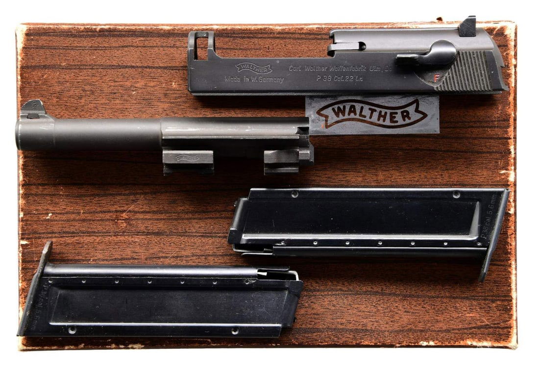 WALTHER P38 - 22 LR CONVERSION KIT.: CAL. 22 LR. S# 4244. Kit includes slide, 5" barrel, 2 springs, 2 - 10 rd. mags., cleaning rod, manual, target & matching Walther box. CONDITION: kit has very good matte finish showing light wear. Box