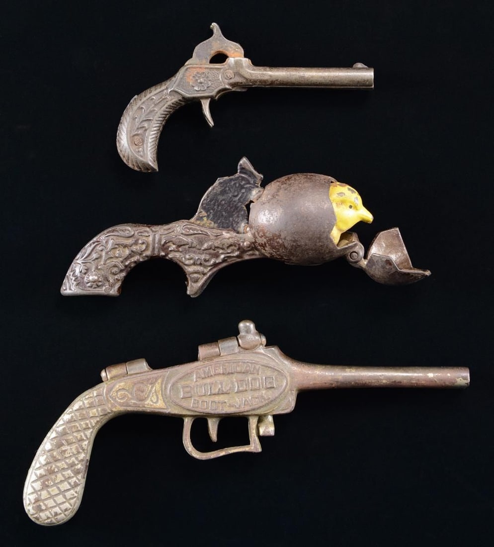 RARE 19TH CENTURY IVES CAST IRON CAP GUN "JUST: OUT" & 2 OTHERS. Among the rarest & most desirable of animated cap guns is "JUST OUT" manufactured by Ives Blakeslee Company, circa 1884. When gun is cocked, egg is closed. When trigger is pulled hen