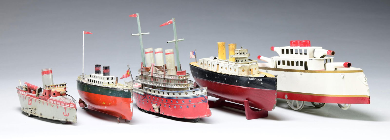 GROUP OF FIVE TIN CLOCKWORK TOY BOATS. (1 of 1)