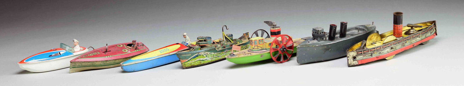 GROUP OF SEVEN TIN TOY BOATS. (1 of 1)