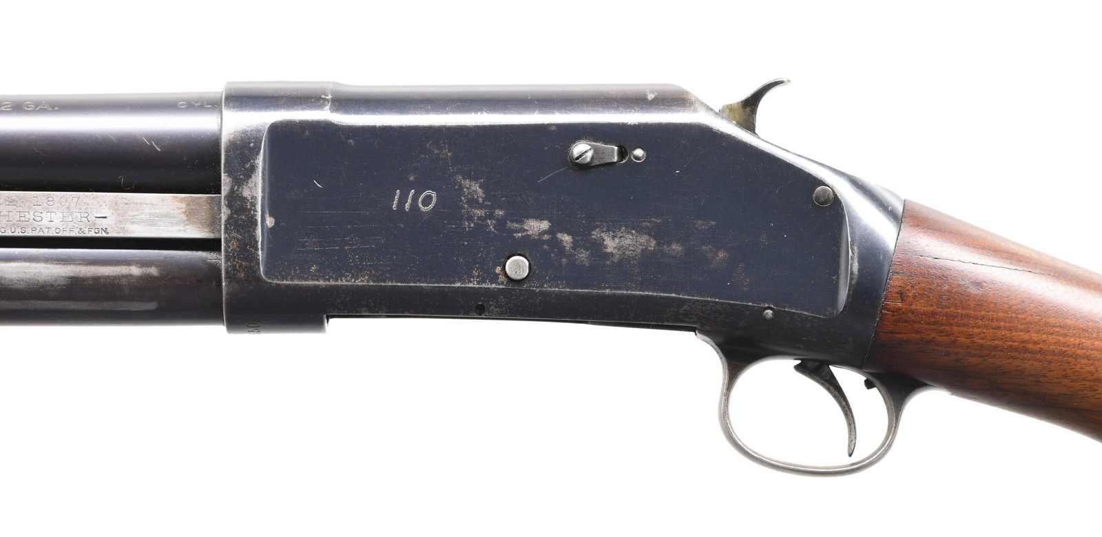 WINCHESTER MODEL 1897 TRENCH STYLE PUMP SHOTGUN.: Cal. 12 ga. S# E719650. Bbl. 20" cyl. bore. Solid frame action. Left side of receiver is electric pencil marked "110" which is likely a Law Enforcement Agency ID number. Bbl. has added bayonet lug & h