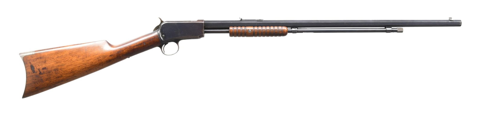WINCHESTER 1890 LATE 2ND MODEL SLIDE ACTION RIFLE.: Cal. 22 Short. S#. 142233. Bbl. 24" octagon w/ standard sporting sights. Tubular mag. 2nd model mortised breech block. Blue finish. Grooved walnut forend & straight grip stock w/ crescent steel buttpl