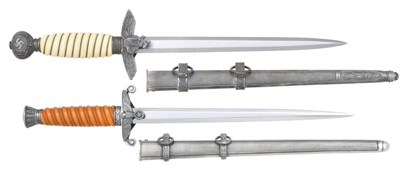 2 WWII GERMAN DAGGERS.: 1) ARMY. Overall length: 15 1/2". Plain blade marked "(knight's head) WKC SOLINGEN". Plated eagle crossguard, oak leaf-decorated pommel, and oak leaf-decorated ferrule. Rich orange grip. Plated scabba