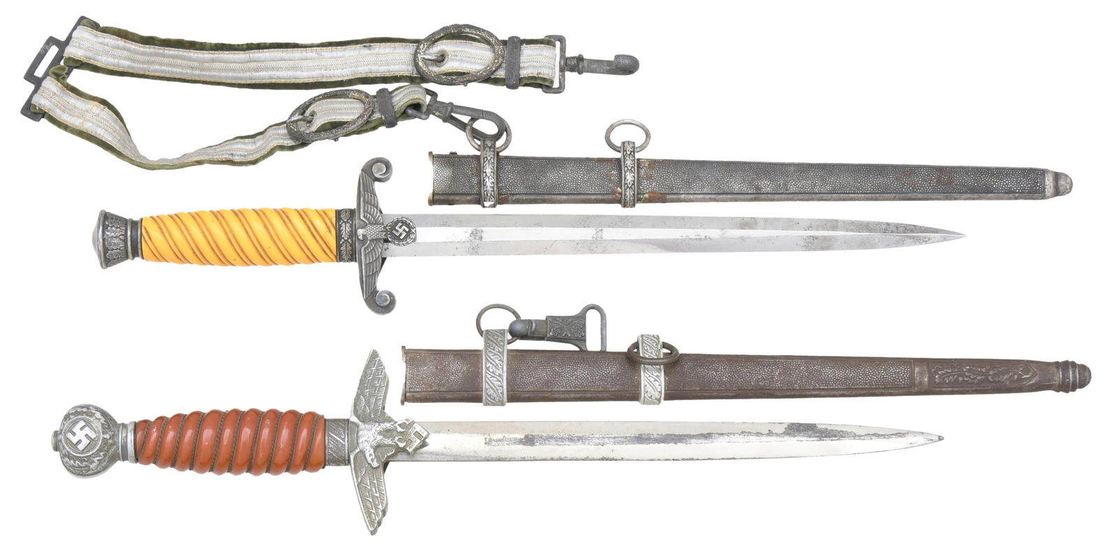 2 WWII GERMAN DAGGERS.: 1) ARMY. This dagger has an overall length of 15 5/8". It has a plain blade marked near the hilt "WMW WAFFEN". Plated eagle crossguard with oak leaf-decorated ferrule and pommel. Light orange composit