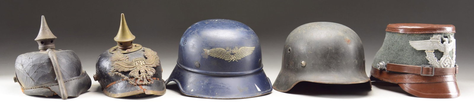 5 GERMAN MILITARY HELMETS.: This lot consists of 2 WWI Prussian spike helmets in poor condition. These two helmets are useful only for parts. / 1 WWII M40 single-decal Wehrmacht helmet. Helmet has a dark gray-green painted finis