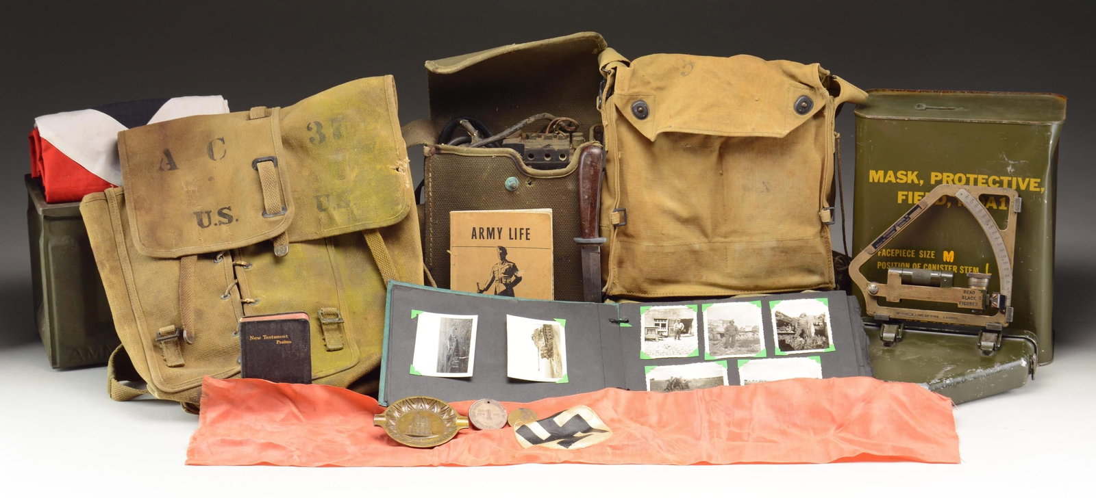 US MILITARY FIELD GEAR, WWII GERMAN BANNERS, A: FIELD TELEPHONE, & MORE. This lot includes 1 protective field mask, M9A1, in its original sealed metal can. / 1 Gunner's quadrant, M1, serial number 160596. This quadrant is designated stock No. 75783