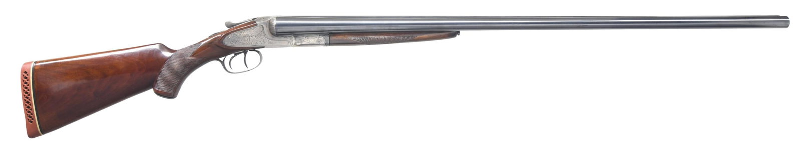 LC SMITH IDEAL GRADE SXS SHOTGUN.: Cal. 12 ga. 2 3/4". S# R15999. Bbl. 32" of London steel. Brass front bead. Case-colored sidelock action. Ideal-grade open pattern foliate engraving with a shaded background having straight lines and w