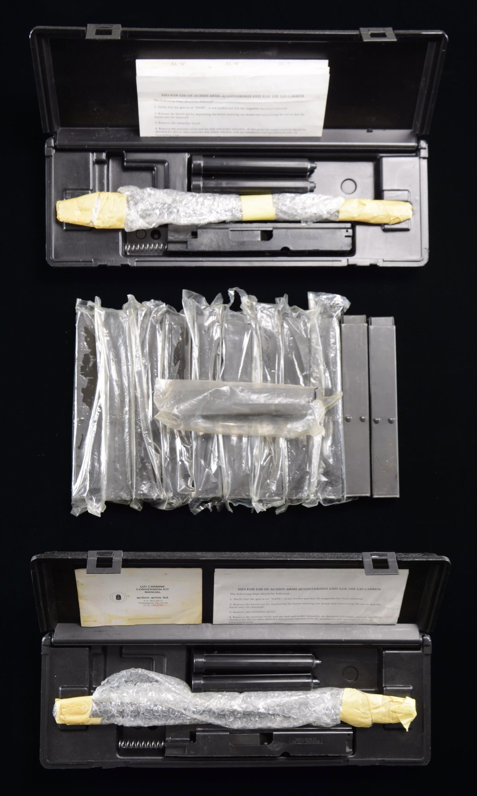 2 ORIGINAL ACTION ARMS UZI 22 LR CONVERSION: KITS & SPARE MAGAZINES. 2 Original Action Arms .22 LR Conversion Subcaliber Kits in original black plastic "Uzi" marked cases. Kits appear complete, including 16" barrel, bolt & magazines. MAGS: Each 