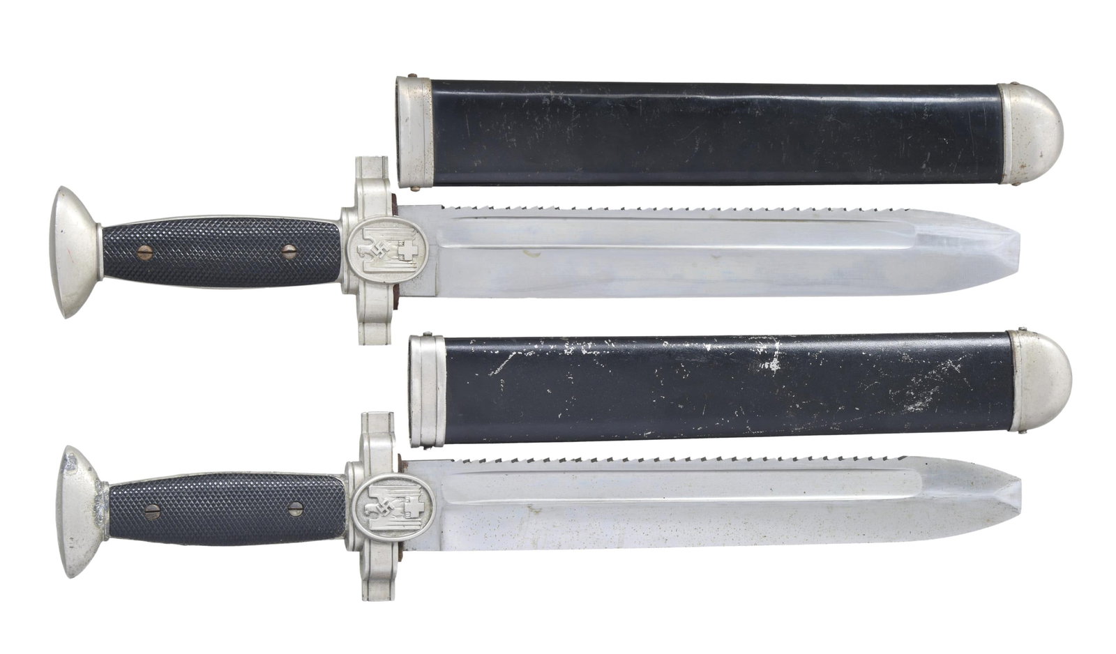 2 WWII GERMAN RED CROSS ENLISTED DAGGERS.: 1) This dagger measures 16 3/8" overall with a plain, sawback, blunted blade featuring a fuller near the spine. The ricasso on the reverse is marked "GES. GESCHUTZT." Plated crossguard featuring a Red