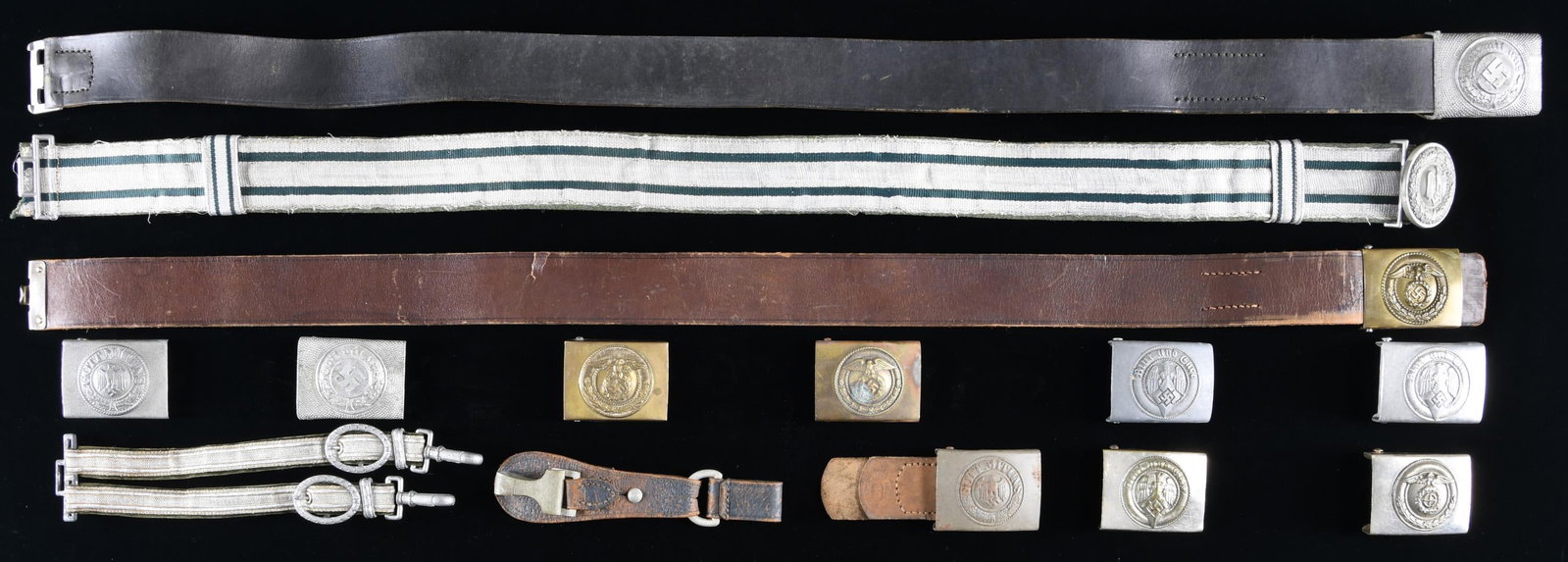 WWII GERMAN BELTS, BUCKLES AND MORE.: This lot consists of 1 Army Officer's buckle with silver bullion belt. / 1 police enlisted buckle in aluminum with matching leather belt. / 1 early political or SA buckle with brown leather belt. / 1 