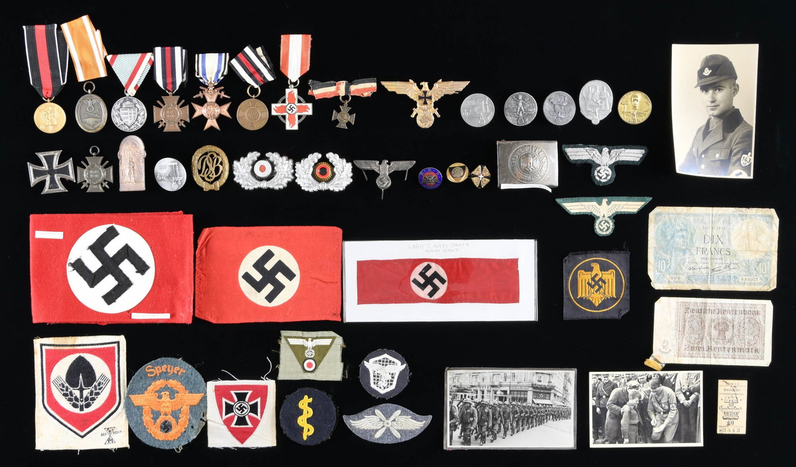WWI & WWII GERMAN MEDALS, BADGES, CLOTH, PINS, &: MORE. This lot includes six Riker mount cases measuring approx. 12" x 8" with a variety of WWII German memorabilia. Included in this lot is 1 small Party-style parade flag measuring 6" x 4". / 1 polic