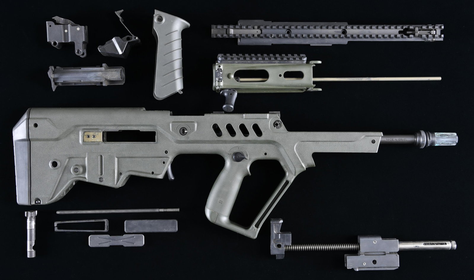 IWI TAVOR SAR SEMI-AUTOMATIC RIFLE PARTS KIT.: Cal. 5.56mm. S# T0041123. Bbl. 17 1/2". Tavor SAR semi-automatic rifle mfg. by IWI. Left side of the receiver exhibits a metal plate with the S# above the model designation and IWI logo. Left side of 