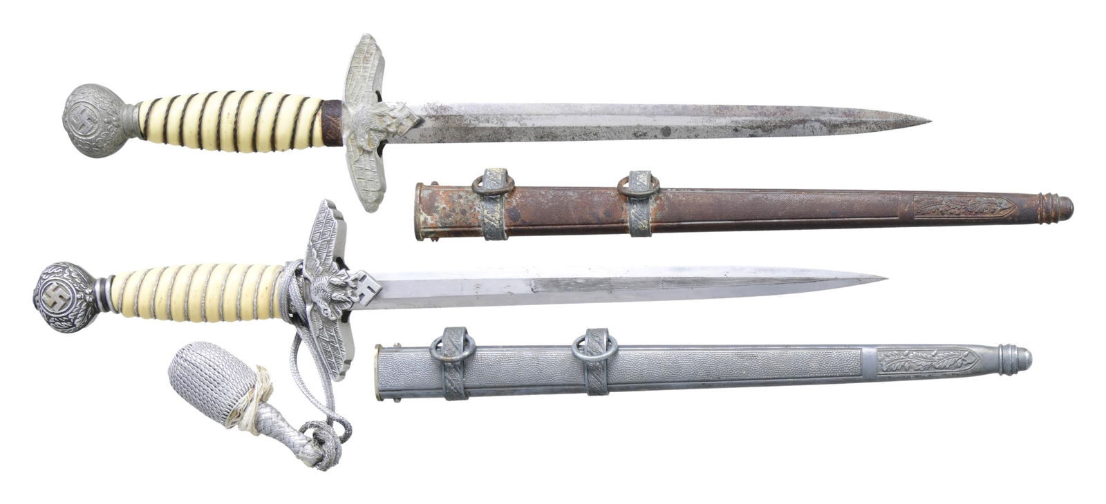 2 WWII GERMAN 2ND MODEL LUFTWAFFE DAGGERS.: 1) Overall length: 17". Plain blade marked near the hilt "F. W. HOLLER SOLINGEN (logo)". Aluminum eagle crossguard with an aluminum oak leaf embellished pommel. Cream colored composite grip with alumi