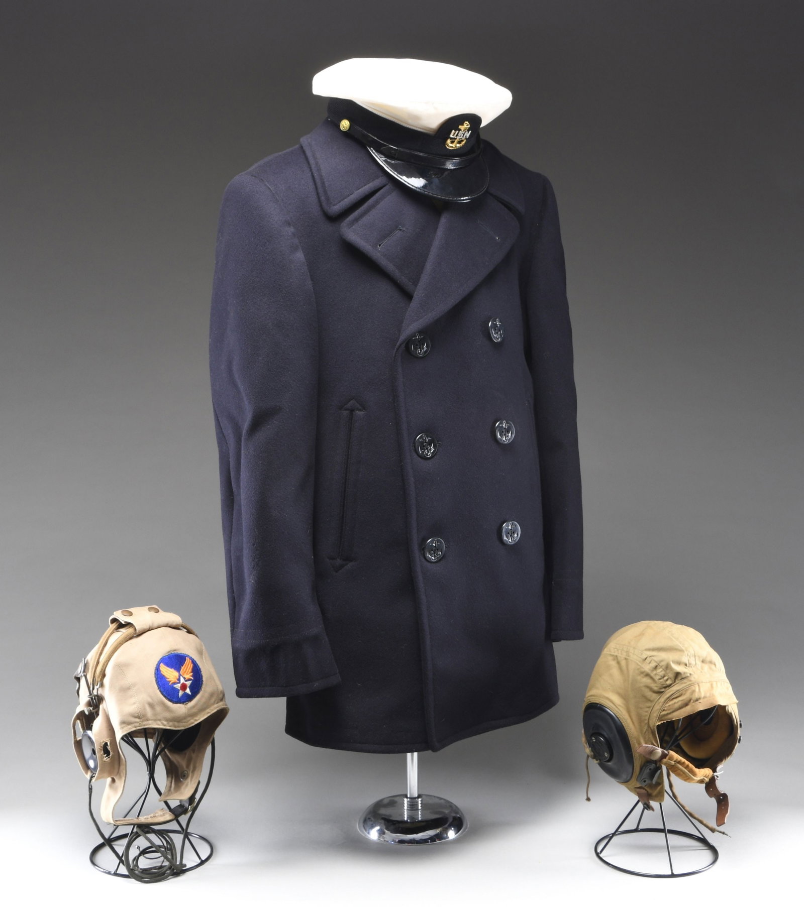 INTERESTING GROUPING OF NAVAL & AVIATION MILITARIA: No.1: US Army tropical flight helmet. The khaki colored cloth helmet is marked inside "SPEC. AN-H-15 / LARGE / BATES SHOE COMPANY / ARMY AIR FORCES". The helmet is fitted w/ earphones marked "RECEIVER