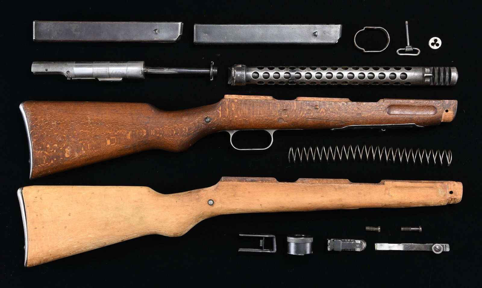 BERETTA MODEL 38A PARTS.: A grouping of Beretta Model 38A parts including the following: 1) 2 shoulder stocks. 1 appears to be as original & includes magazine well bottom plate, trigger guard, steel sling swivel & butt plate. 