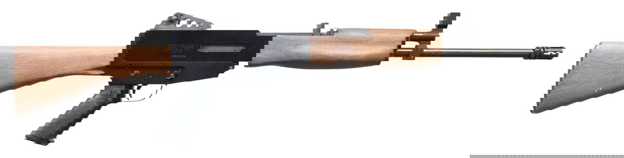 EARLY GWINN FIREARMS BUSHMASTER RIFLE.: Cal. 5.56mm. S# R001034. Bbl.18". A very early Bushmaster Rifle from the original Bangor Maine location. Threaded barrel. terminated w/ A1 flash hider. Protected post front sight. Top mounted charging