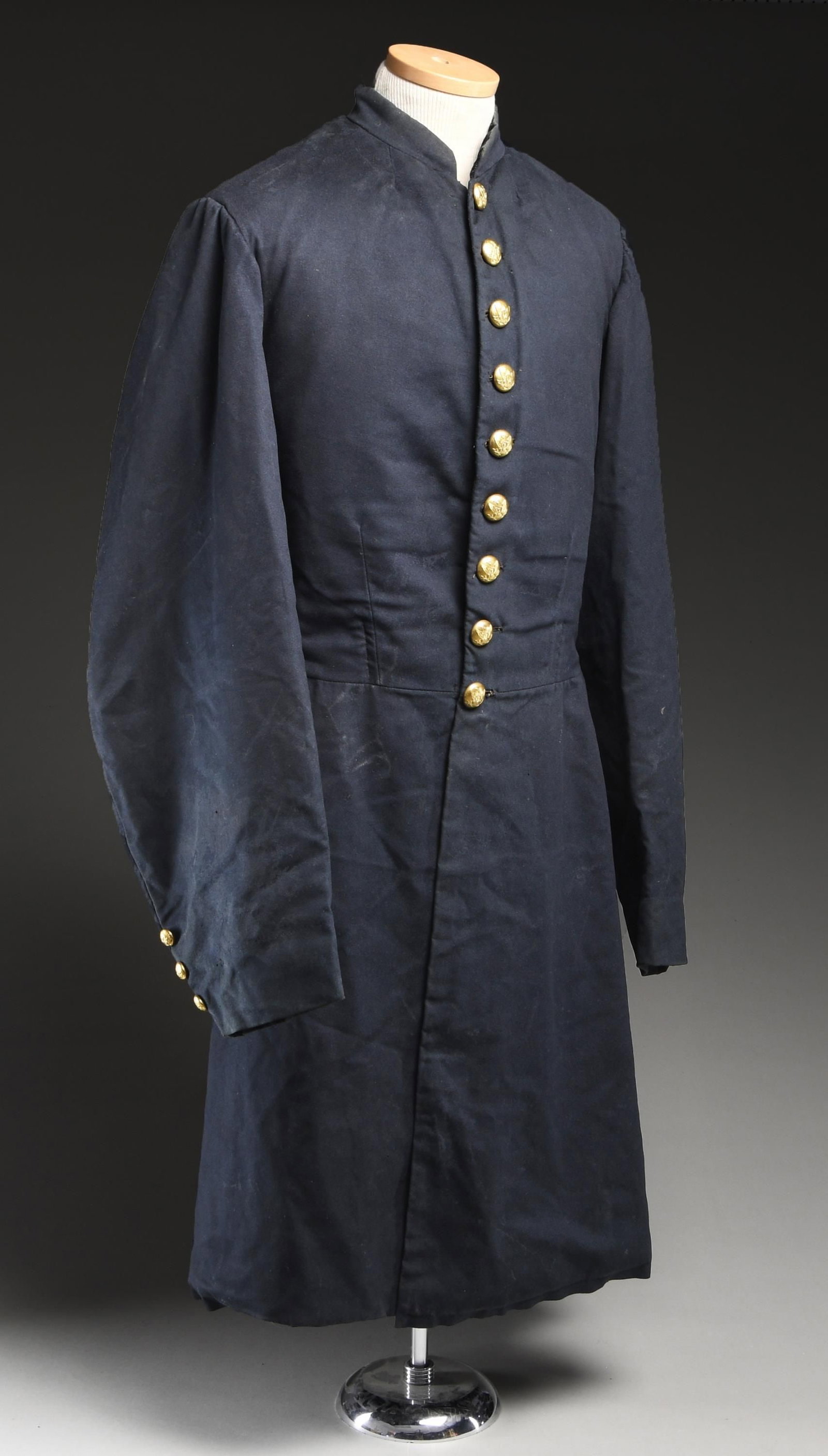 CIVIL WAR UNION OFFICER'S 9 BUTTON FROCK COAT.: A good standard example of a Union officer's frock coat of the Civil War period. The coat is void of rank insignia but does have all of its eagle "I" buttons indicating the owner was attached to an in