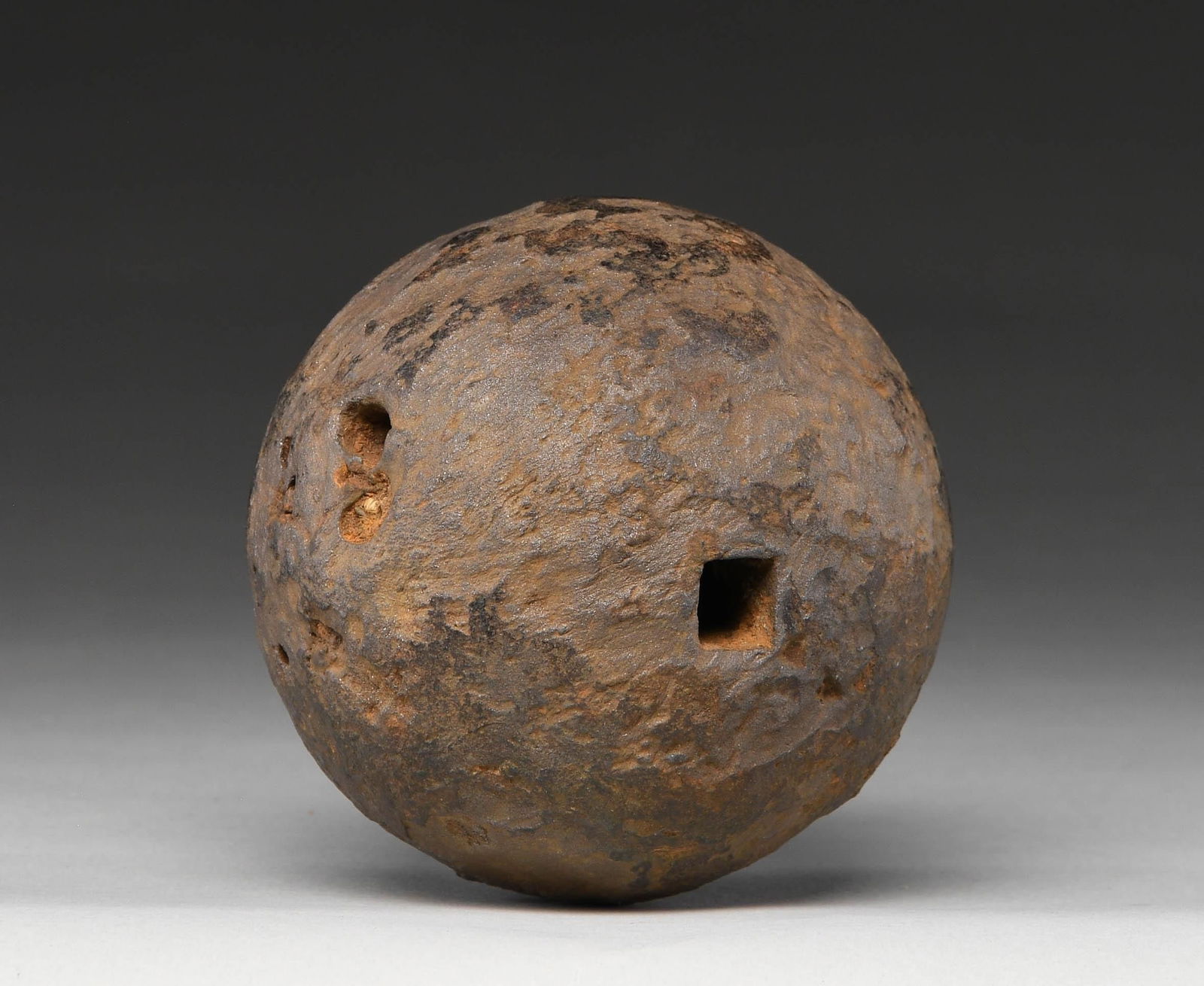 CANNONBALL: This cannonball appears to be of about 8 pounder size. It has a rectangular hole through the center indicating possible use 1/2 of a bar shot. A bar shot consisted of 2 balls of equal size connected b