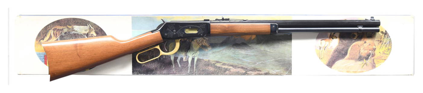 WINCHESTER MODEL 94 CANADIAN CENTENNIAL LEVER: ACTION RIFLE WITH STYROFOAM INSERT & SLEEVE. Cal. 30-30. S# 68389. Bbl. 20". Model 94 lever action rifle mfg. by Winchester commemorating Canada's 1967 centennial. The left quarter flat of the octagon
