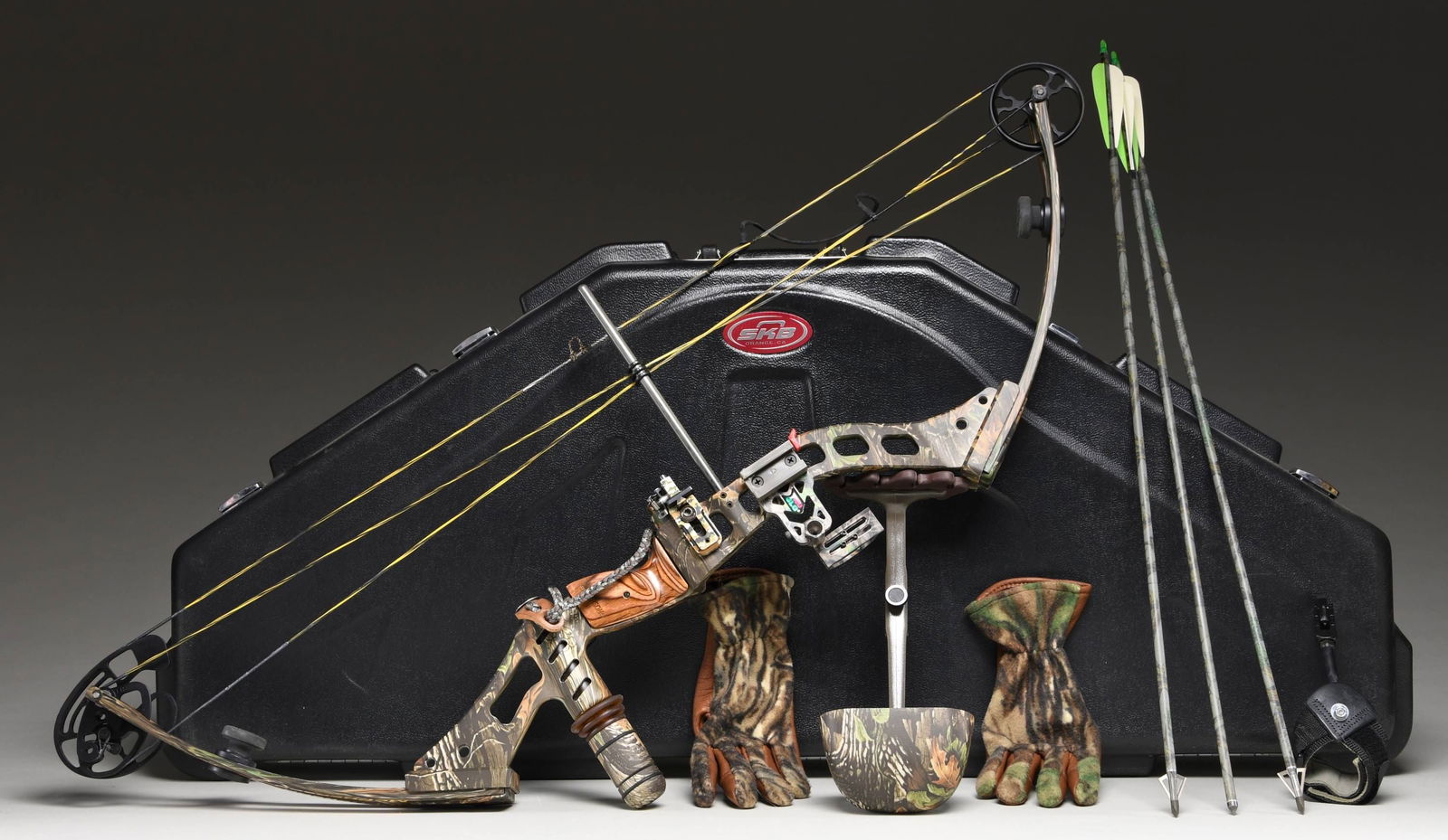 MCPHERSON 38 SPECIAL COMPOUND BOW.: S# 11130208. Camo finished compound bow with 29" draw & 60 lb. draw weight. Tru-Glo sight. UNATTACHED ACCESSORIES: case containing gloves, quiver, 12 arrows & other accessories. CONDITION: appears nea