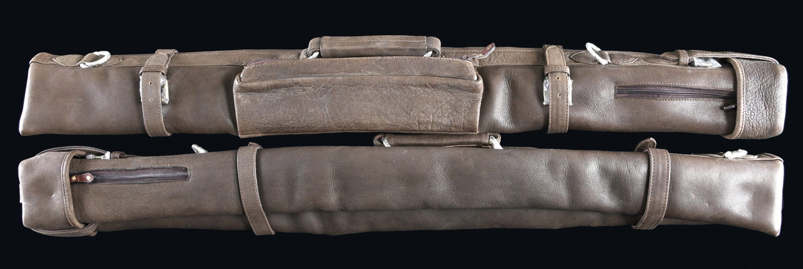 2 SUPERB TRAVEL CASES FOR A TAKE-DOWN LONG BOW.: These incredibly well-made buffalo hide cases measure approx. 40" x 4" x 4" and were specially designed by Lewis Drake to carry the Jack Harrison style take-down long bow. The cases have heavy metal h