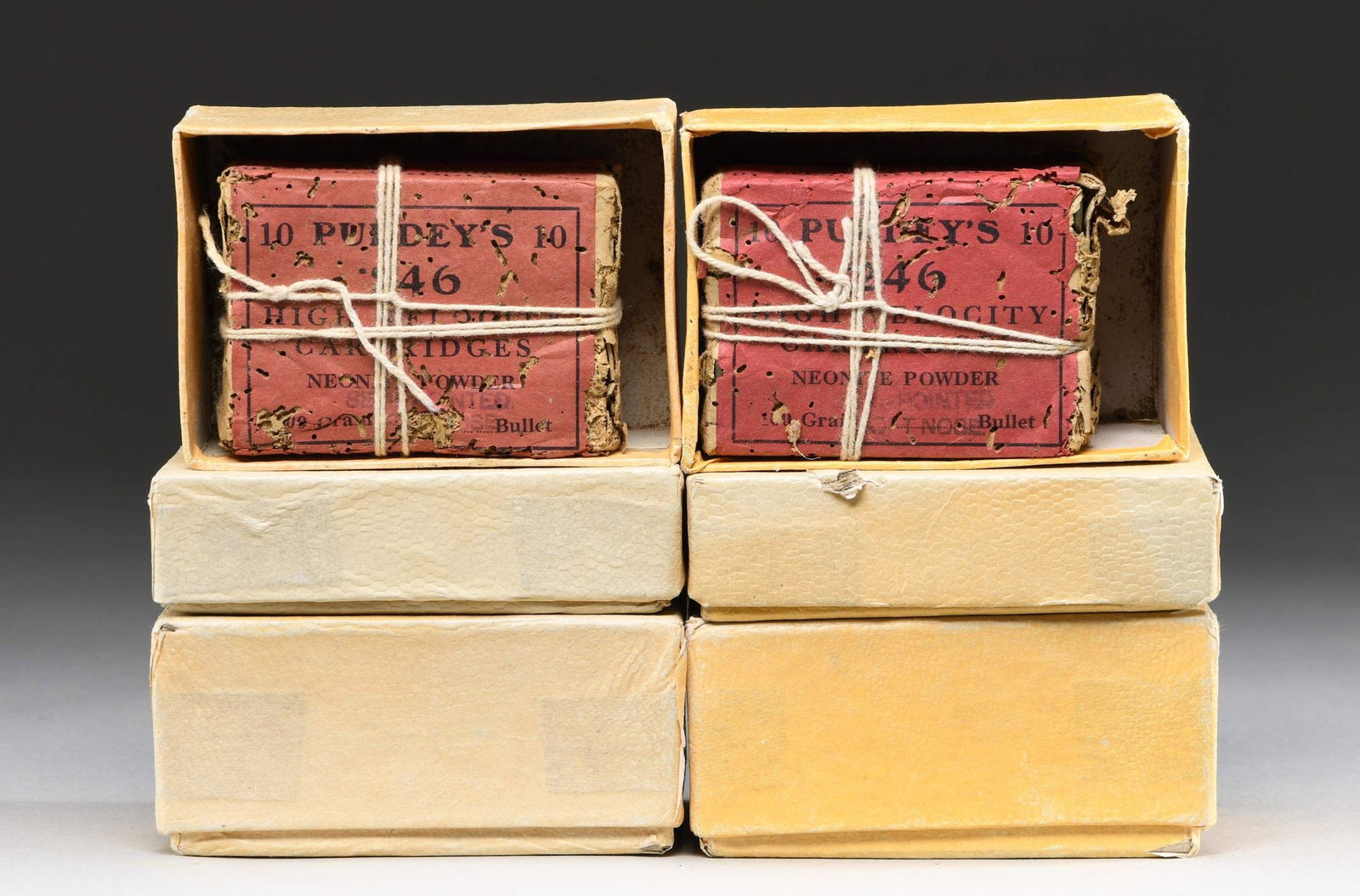 ABOUT 100 RDS. OF KYNOCH 246 PURDEY AMMO.: This lot consists of about 100 rds. of Kynoch 246 Purdey ammo. Ammo is in 10 rd. red boxes that are further housed in modern plain boxes. CONDITION: Kynoch boxes show heavy wear with missing pieces &